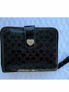 Coach brand black perforated liquid gloss wallet. Never used.